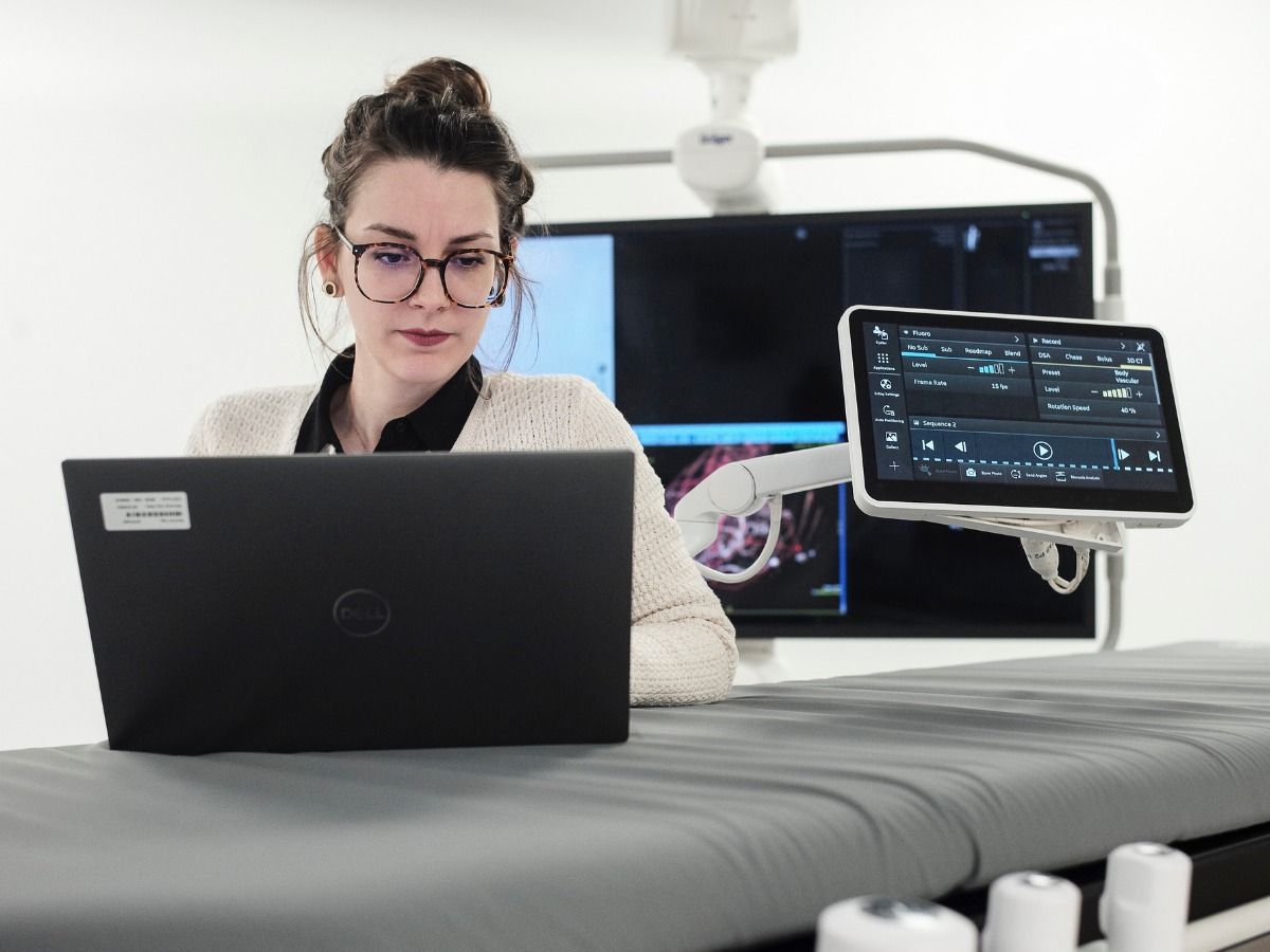 Image of a healthcare worker using a laptop in a healthcare setting.